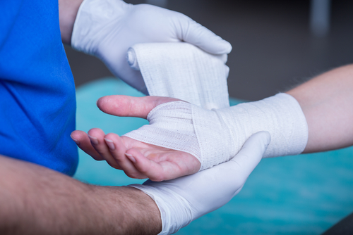 doctor bandaging hand and wrist