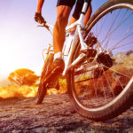 person on bicycle on dirt road