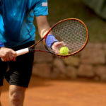 tennis player preparing to serve the ball